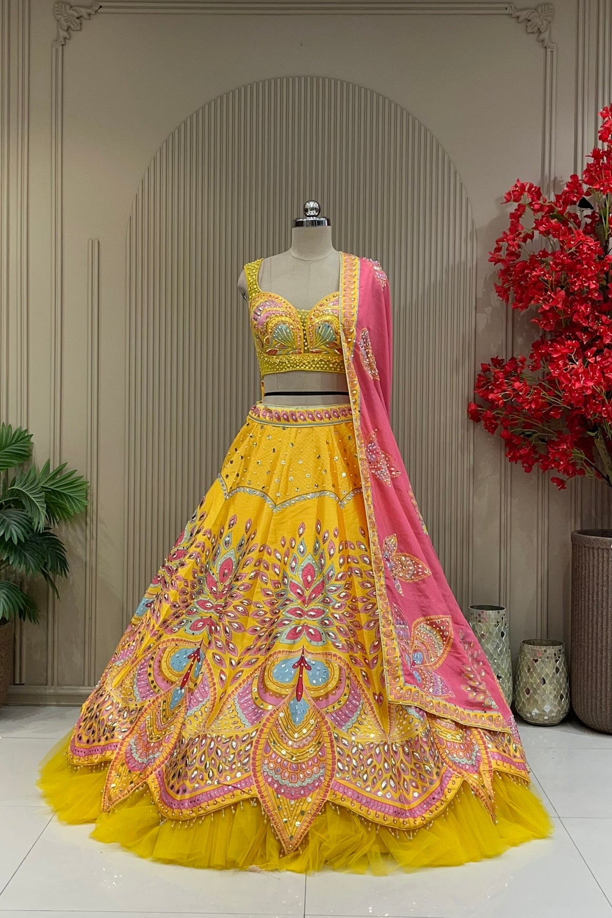 Yellow lehenga with designer hand-work blouse, full front view on mannequin with contrast pink dupatta