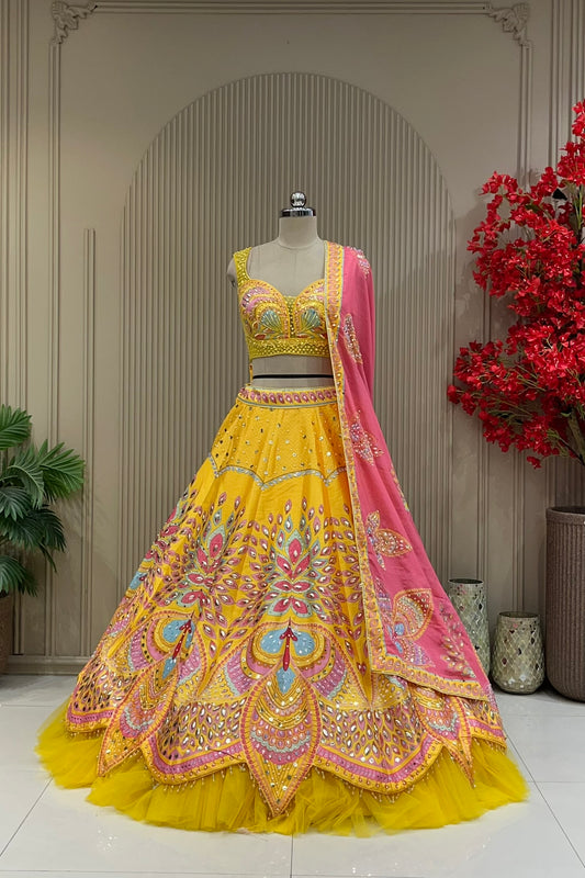 Yellow lehenga with designer hand-work blouse, full front view on mannequin with contrast pink dupatta