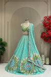 Aqua lehenga set showing mirror-work skirt and mirror-floral hem border