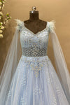 Beautifully hand crafted bridal gown in sky colour with selfie long sleeves and feather