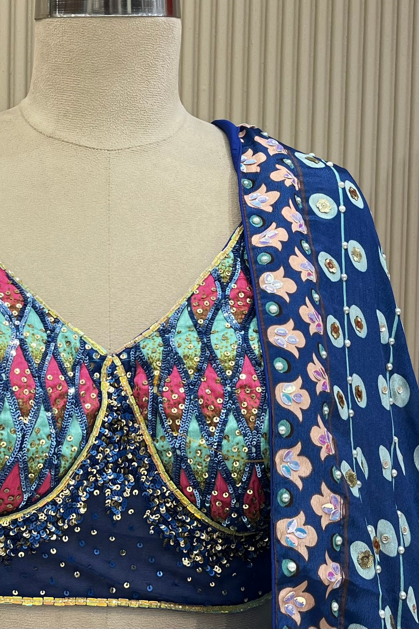 Close-up of sequin lattice hand-work blouse and floral medallion dupatta border