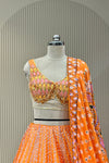 Detail shot of orange dupatta mirror border and sequin dot pattern
