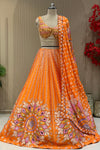 Orange lehenga set showing sunburst medallion hem and sequin border dupatta