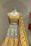 Close-up of mustard printed blouse and lehenga waistband showing floral contrast border