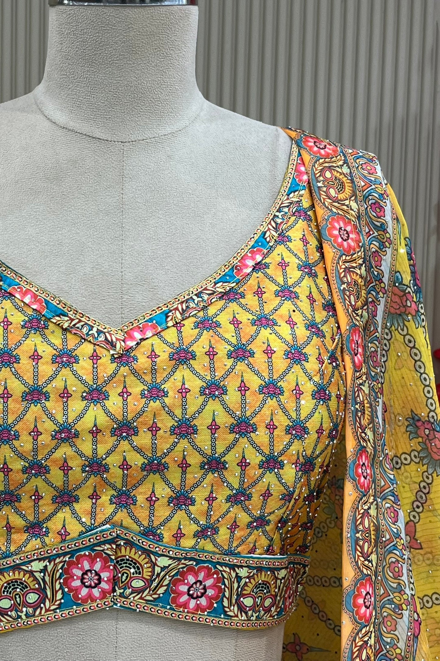 Detail shot of sleeveless V-neck blouse with diamante embellishment and printed dupatta border