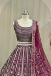 Close-up front view of printed blouse and lehenga waistband with net dupatta drape