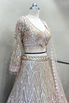 Side profile showcasing the 3D texture of the heavy beads work and sheer sleeve craftsmanship on a designer reception lehenga.