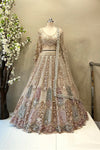 Full-length view of a luxury multi-color heavy beads work bridal lehenga with arched panel embroidery and a long-sleeve blouse at Urban Dulhaniya.