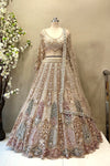 etailed shot of a flared antique gold lehenga featuring dense multi-color heavy beads work and a wide scalloped border.