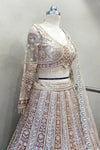 Side profile of a heavy beads work lehenga blouse showcasing the texture of the metallic beads and sheer sleeve craftsmanship.