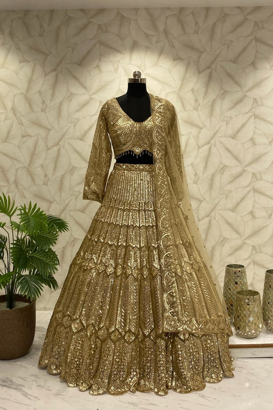 Front view of the Golden Dream designer lehenga featuring complete heavy fabrication work by Urban Dulhaniya
Close-up detail of premium heavy fabrication and embellishments on a luxurious gold evening lehenga.
