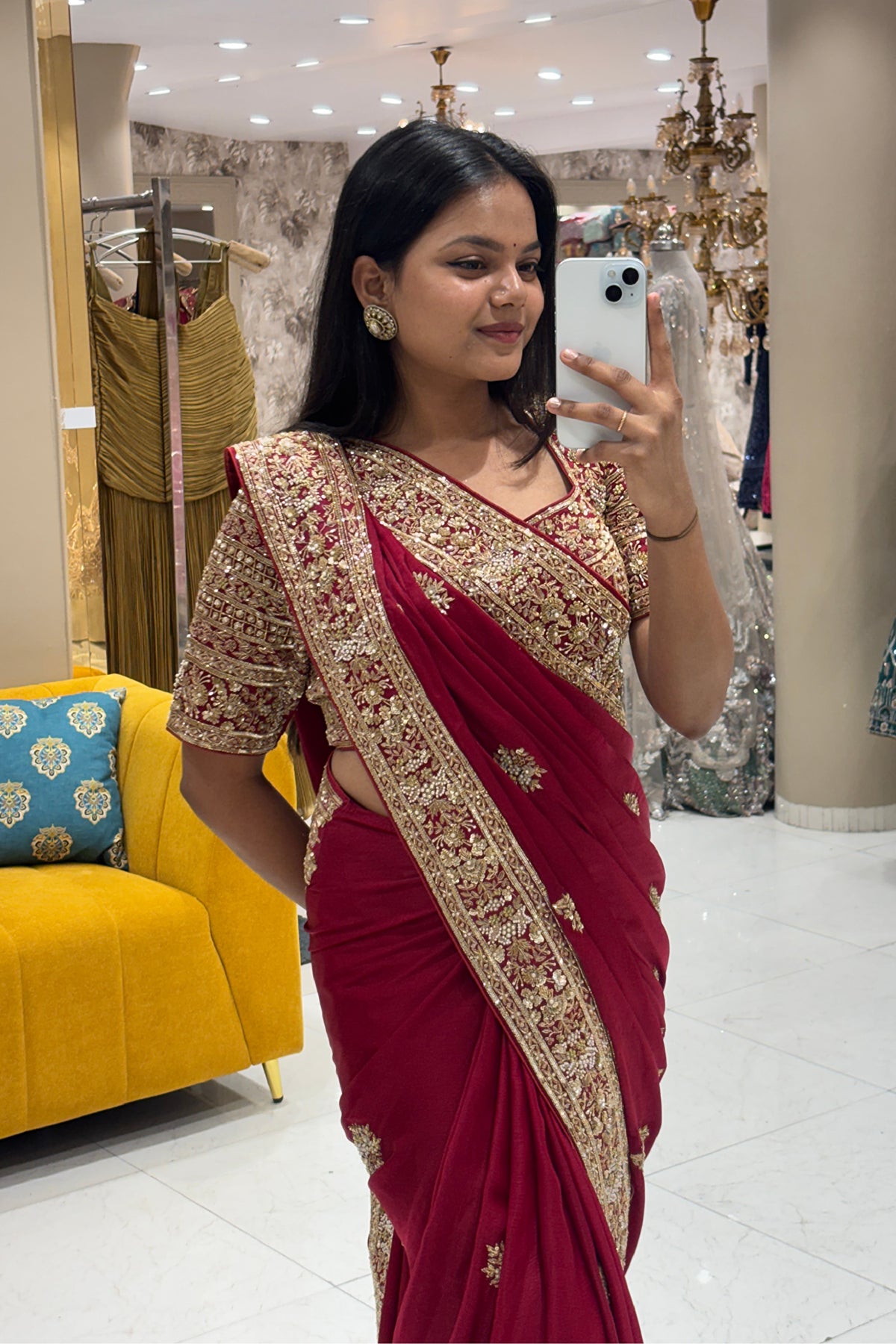 Close-up of a premium maroon party wear saree highlighting the heavy pure handwork gold embroidered half-sleeve blouse and intricate detailing.