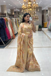 Full-length view of a woman taking a mirror selfie wearing a luxury pastel geometric pure handwork designer saree at the Urban Dulhaniya boutique.