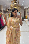 Close-up of a premium pure handwork saree highlighting intricate zardosi and sequin embroidered borders over a peach and beige block pattern.