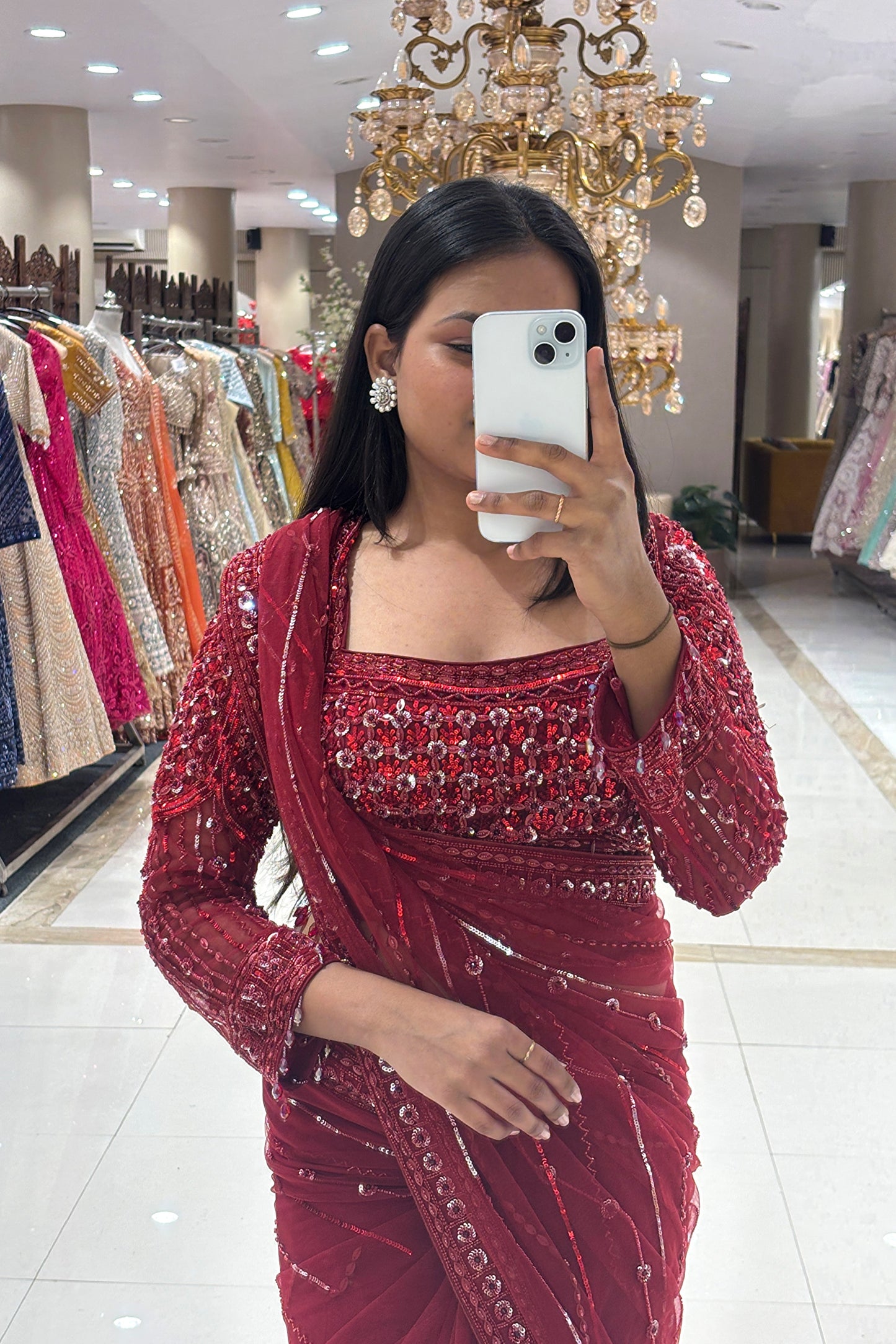Close-up of a designer pure handwork red net saree highlighting a heavy sequin and glass bead embroidered square-neck long-sleeve blouse.
