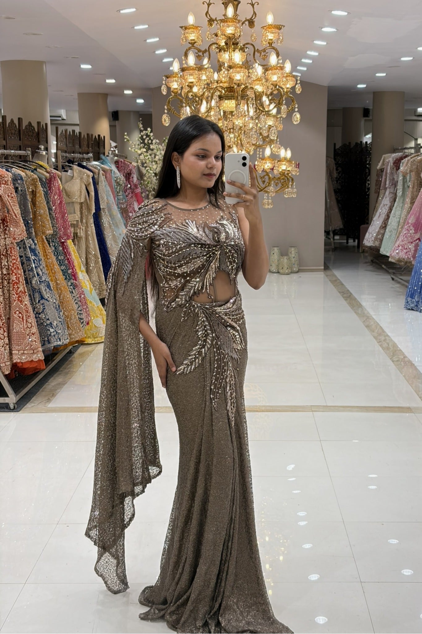Full-length view of a designer mermaid silhouette reception gown highlighting an illusion neckline, side cutout, and heavy Indo-Western embellishments.