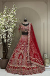 Heritage crimson red bridal lehenga on a mannequin featuring heavy gold cutdana, sequins, and zarkan highlights with cutwork designer sleeves and tassel detailing.