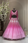 Hot pink ombre bridal lehenga on a mannequin featuring heavy vertical cutdana lines, zarkan highlights, and a choker-style dupatta with poth moti embroidery.