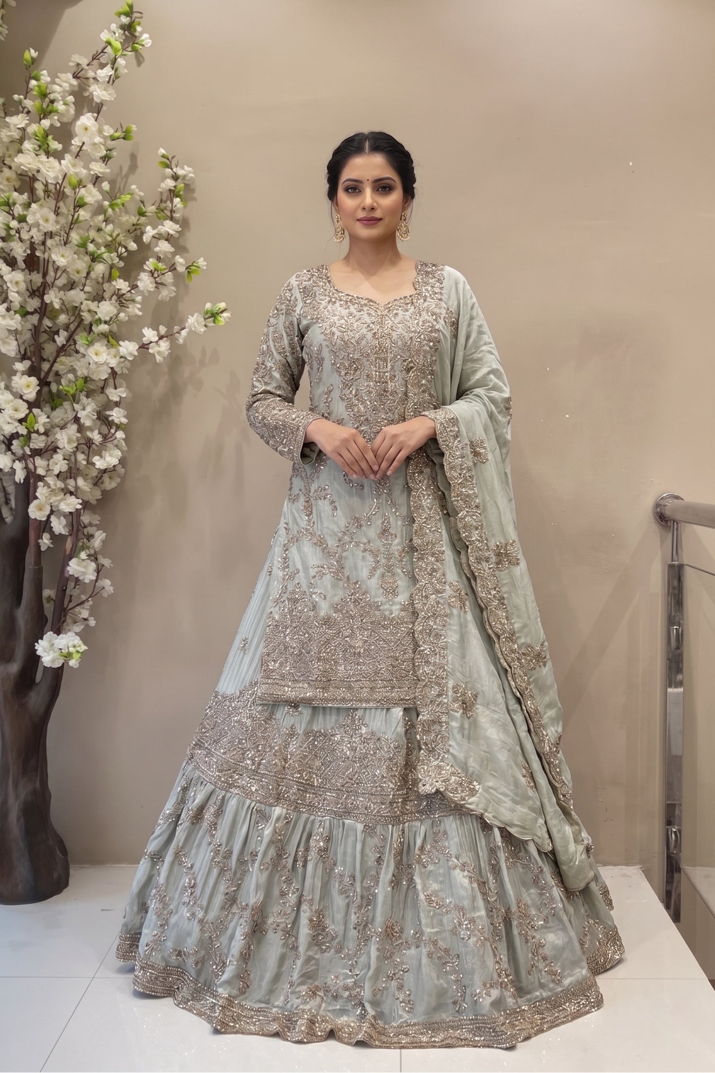 Designer sage green long kurta lehenga set with flared skirt and scalloped dupatta for brides.