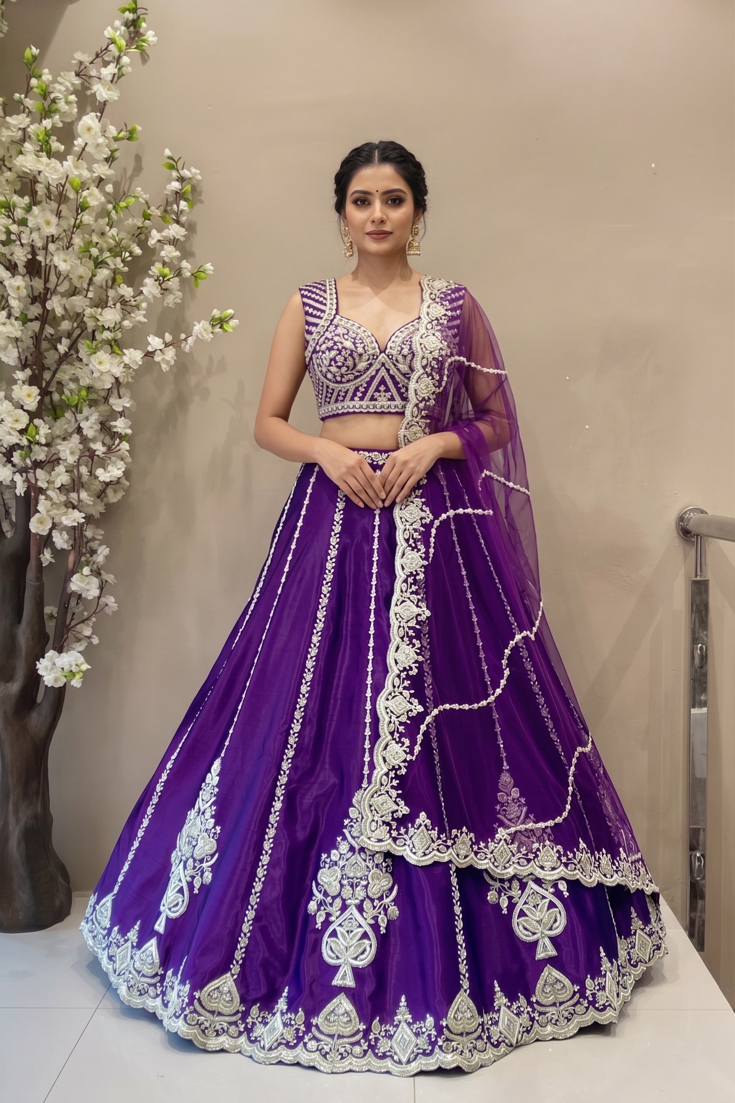 Luxury royal purple silk lehenga with vertical embroidery and scalloped border for bridal sangeet or reception.