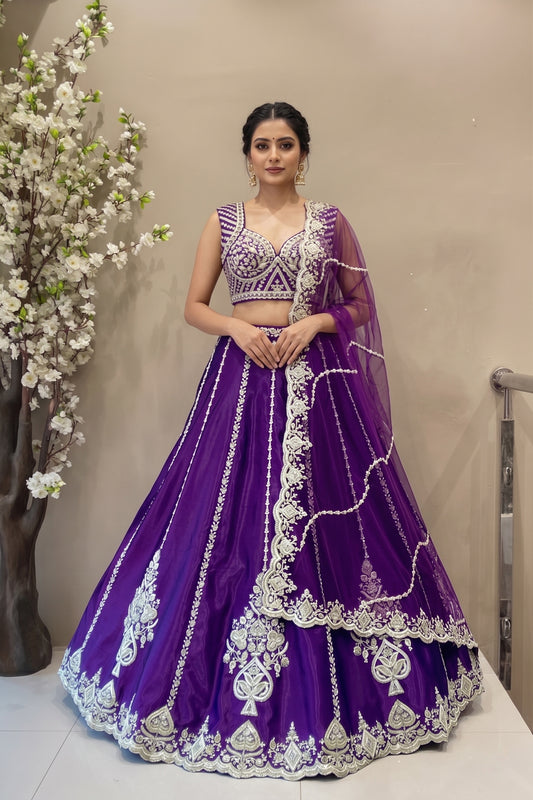 Luxury royal purple silk lehenga with vertical embroidery and scalloped border for bridal sangeet or reception.
