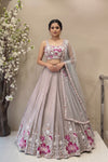Designer mauve silk lehenga with pink floral handwork and flared silhouette for bridal or sangeet wear.