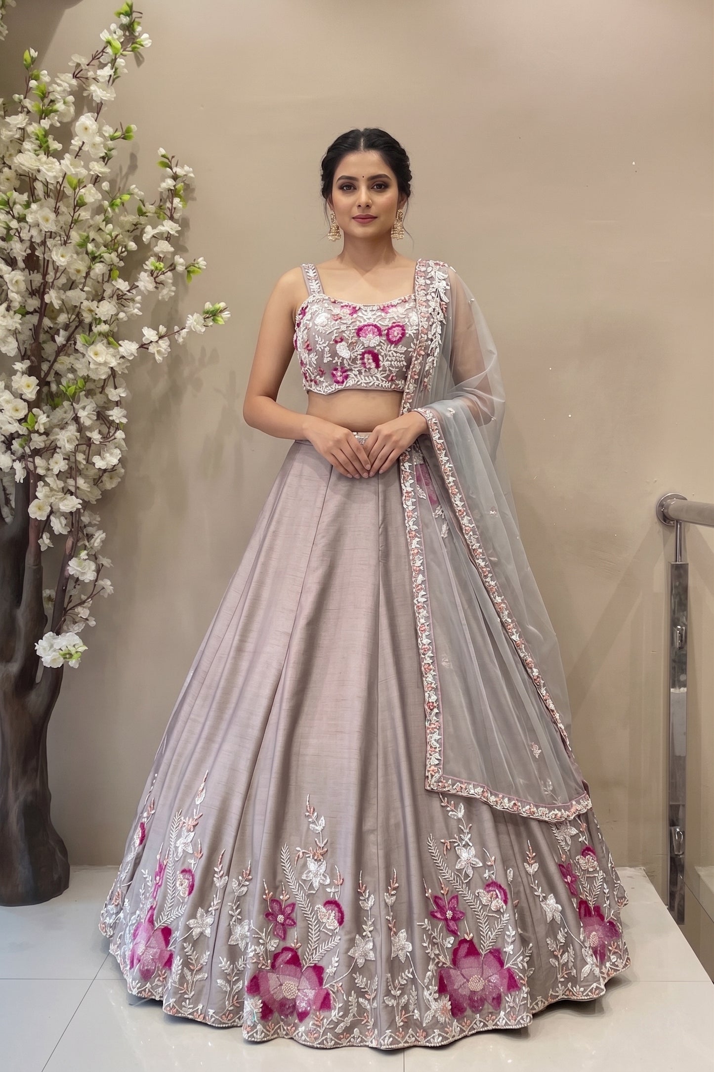 Designer mauve silk lehenga with pink floral handwork and flared silhouette for bridal or sangeet wear.