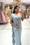 Full-length mirror selfie of a woman wearing a luxury ice blue pre-draped Indo-Western saree with a sheer handwork corset blouse at the Urban Dulhaniya boutique on MG Road, Pune.