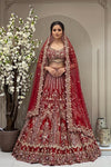 Heritage crimson red bridal lehenga on a mannequin featuring heavy gold cutdana, sequins, and zarkan highlights with cutwork designer sleeves and tassel detailing.