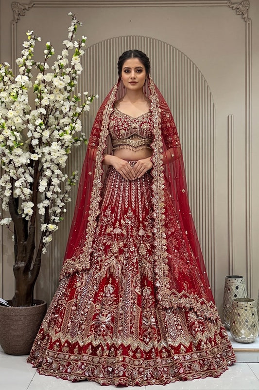 Heritage crimson red bridal lehenga on a mannequin featuring heavy gold cutdana, sequins, and zarkan highlights with cutwork designer sleeves and tassel detailing.