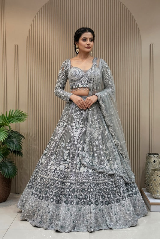 Luxury Pewter Grey bridal lehenga with cutdana, beads, zarkan highlights and heavy silver patti embroidery, featuring a corset-style full-sleeved blouse and scalloped net dupatta.