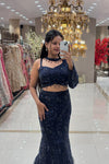 Close-up of a designer navy blue mermaid lehenga featuring heavy monochromatic sequin embroidery and a unique choker-neck long-sleeve blouse for cocktail parties.