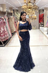 Full-body shot showcasing the figure-hugging mermaid silhouette and intricate beadwork of a premium midnight blue reception lehenga.