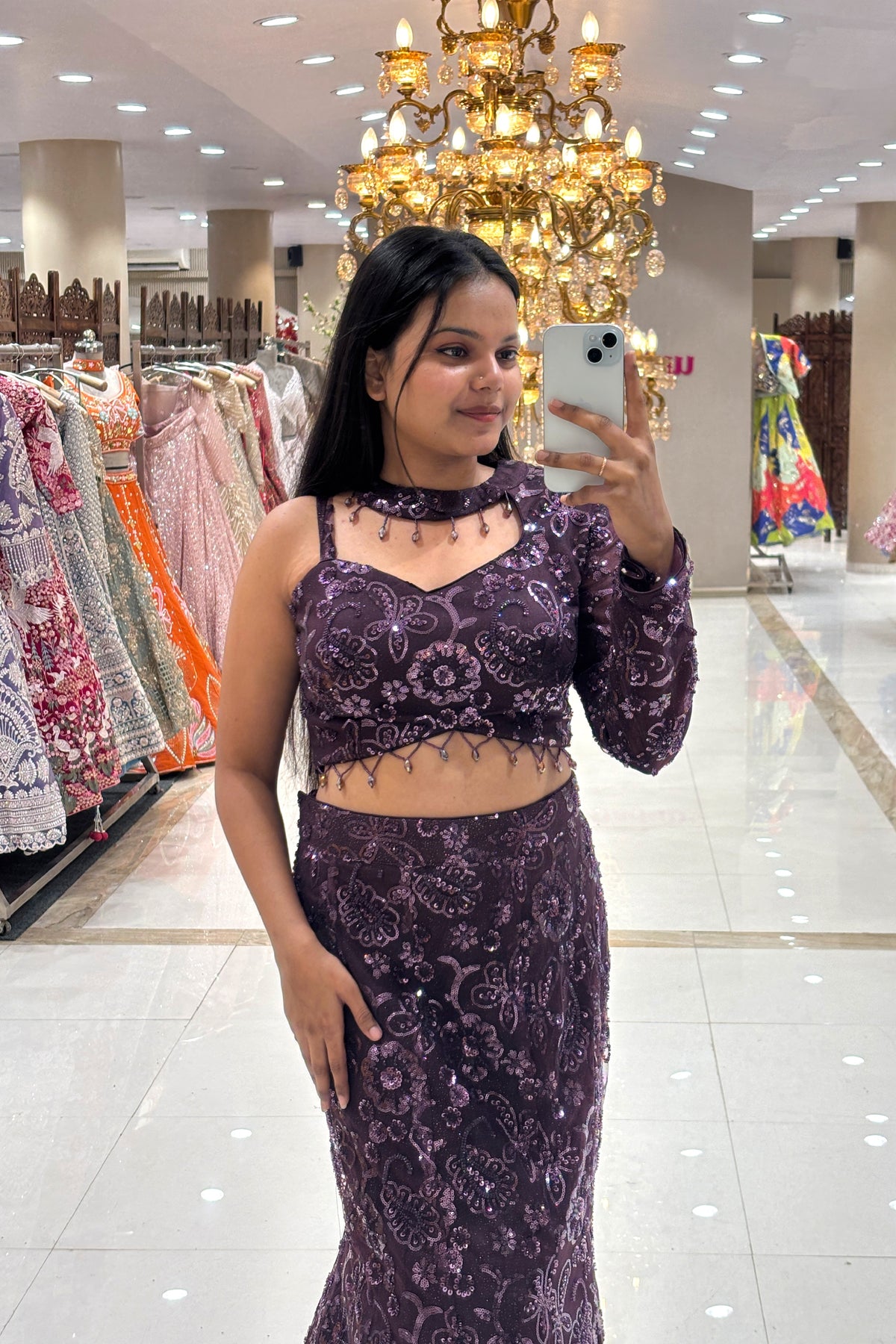 Full-body shot showcasing the figure-hugging mermaid silhouette and intricate floral beadwork of a premium aubergine purple reception lehenga on MG Road, Pune.