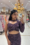 Close-up of a designer plum purple mermaid lehenga featuring heavy monochromatic sequin embroidery and a unique choker-neck long-sleeve blouse for cocktail parties.