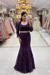 Full-length view of a woman wearing a luxury violet fishcut Indo-Western lehenga with heavy sequin embroidery for cocktail parties.
Full-body mirror selfie showcasing a glamorous deep purple mermaid lehenga silhouette at the MG Road, Pune boutique.