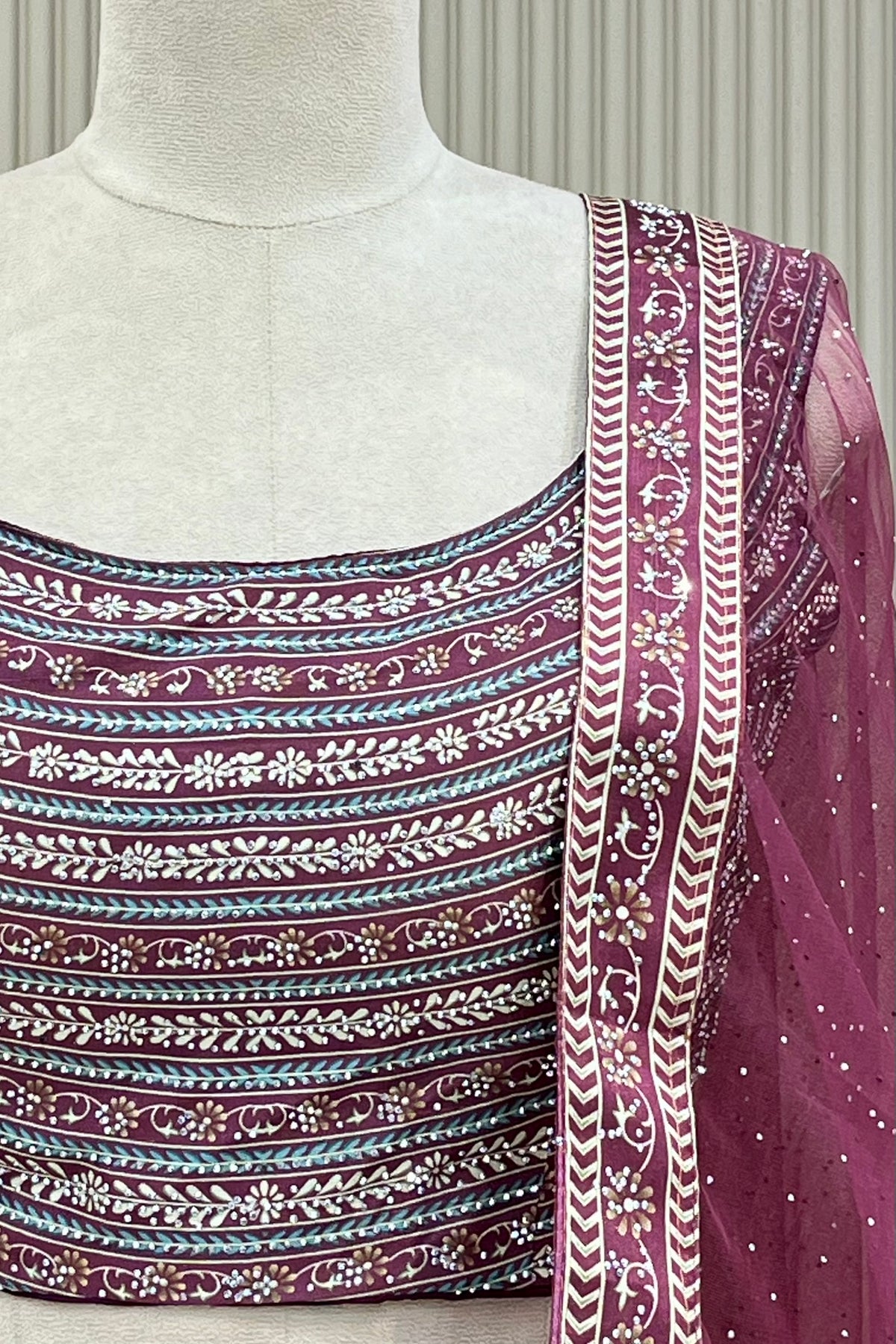 Detail shot of printed blouse banding and net dupatta border with stone scatter