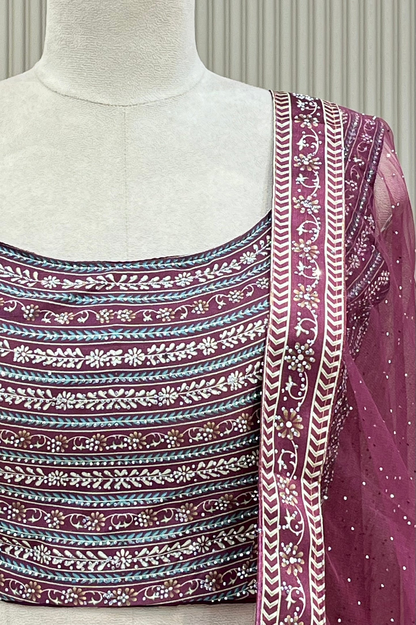Detail shot of printed blouse banding and net dupatta border with stone scatter